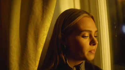 a woman looking out a window at the outside