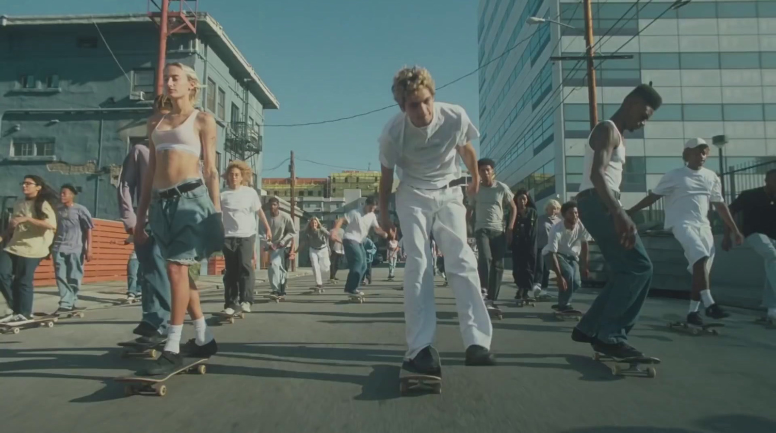 a group of people riding skateboards down a street