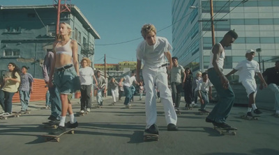 a group of people riding skateboards down a street