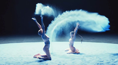 a couple of women standing on top of a snow covered ground