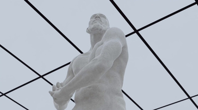 a statue of a man holding a tennis racquet