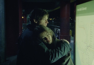 a man and a woman hugging in front of a map