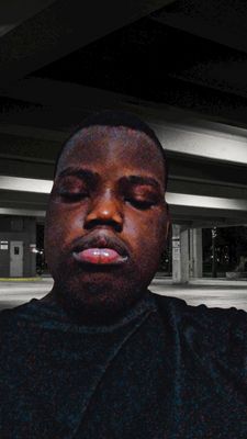 a man in a parking garage with his eyes closed