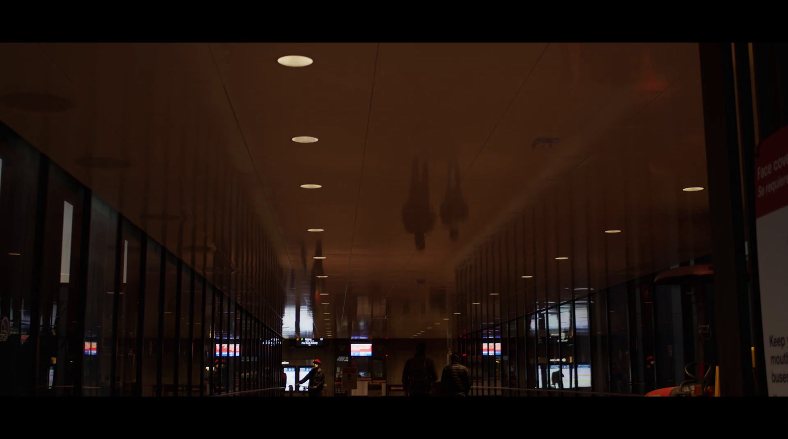 a long hallway with a lot of lights on the ceiling