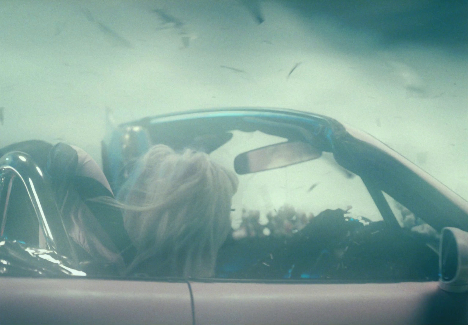 a woman sitting in a car with her head out the window