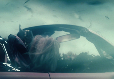 a woman sitting in a car with her head out the window