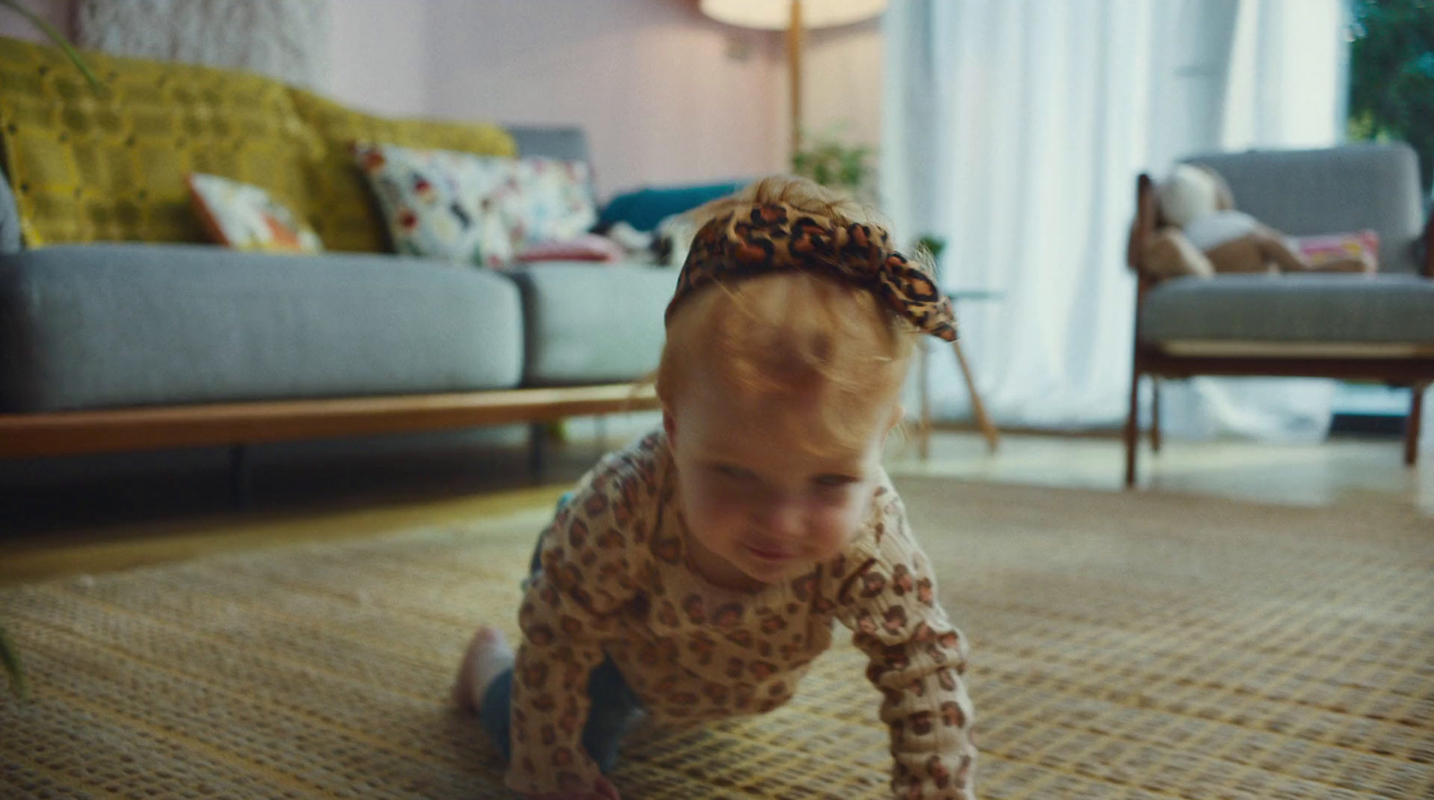 a little girl crawling on the floor in a living room