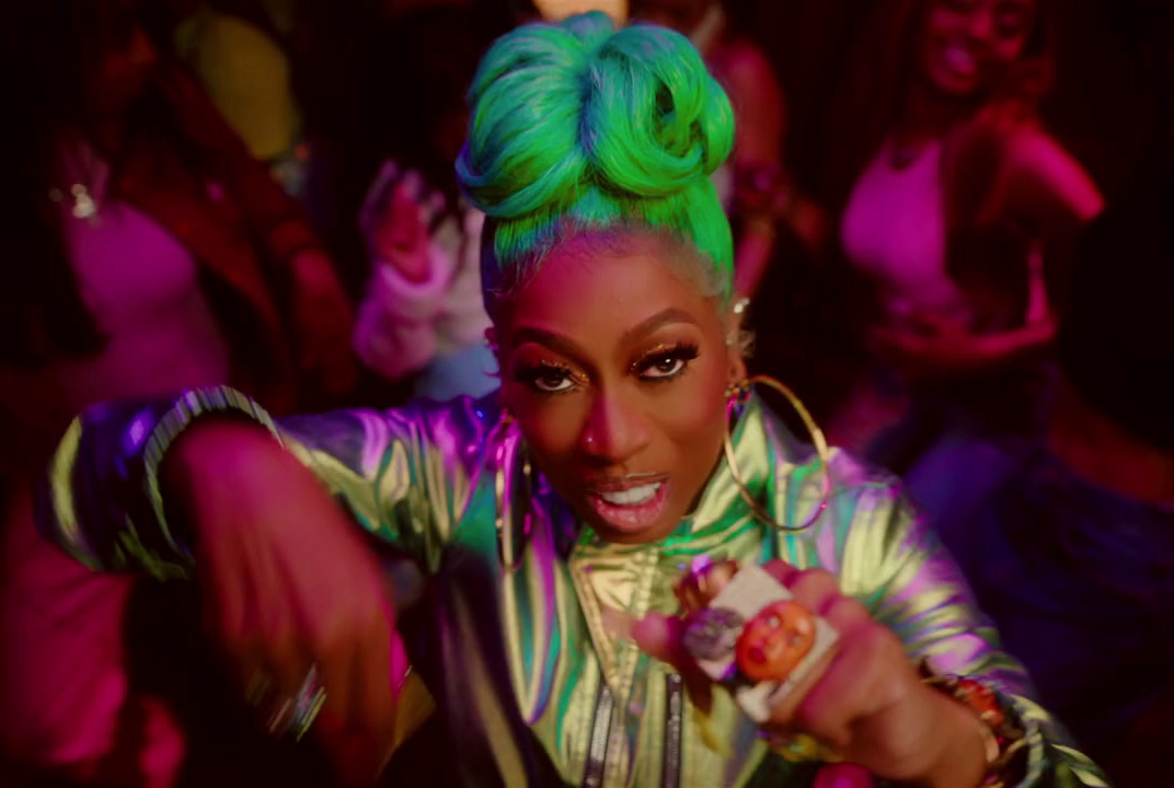 a woman with bright green hair is dancing