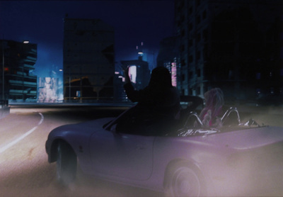 a car driving down a city street at night