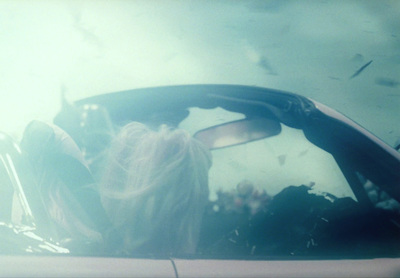 a woman sitting in a car looking out the window