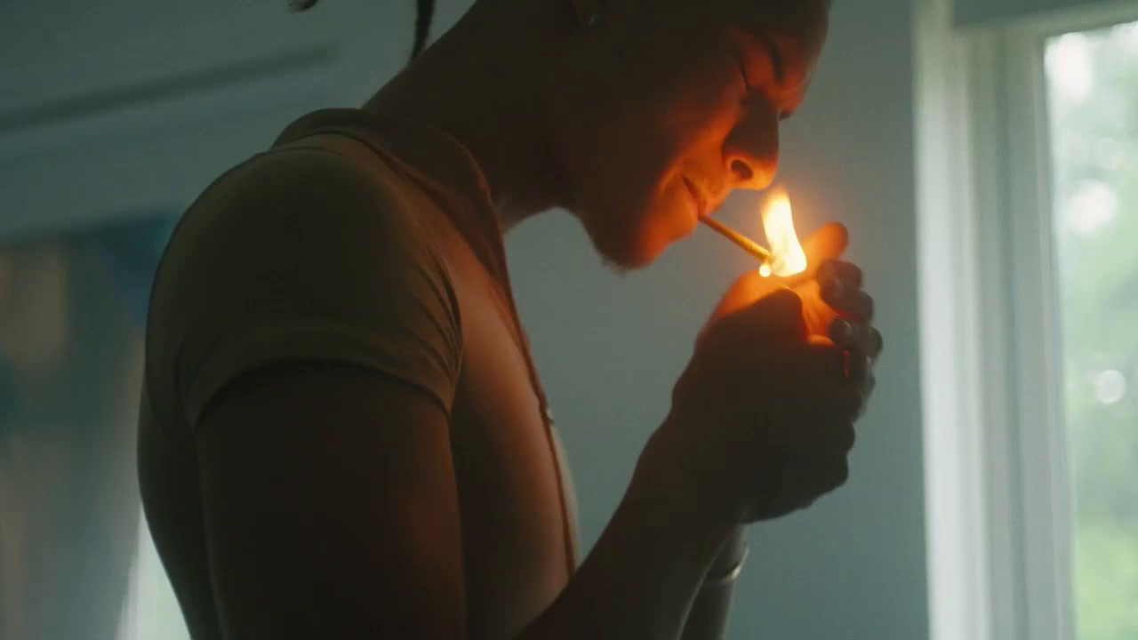 a woman holding a lit cigarette in her hand