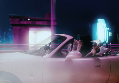 a woman sitting in the driver's seat of a white car