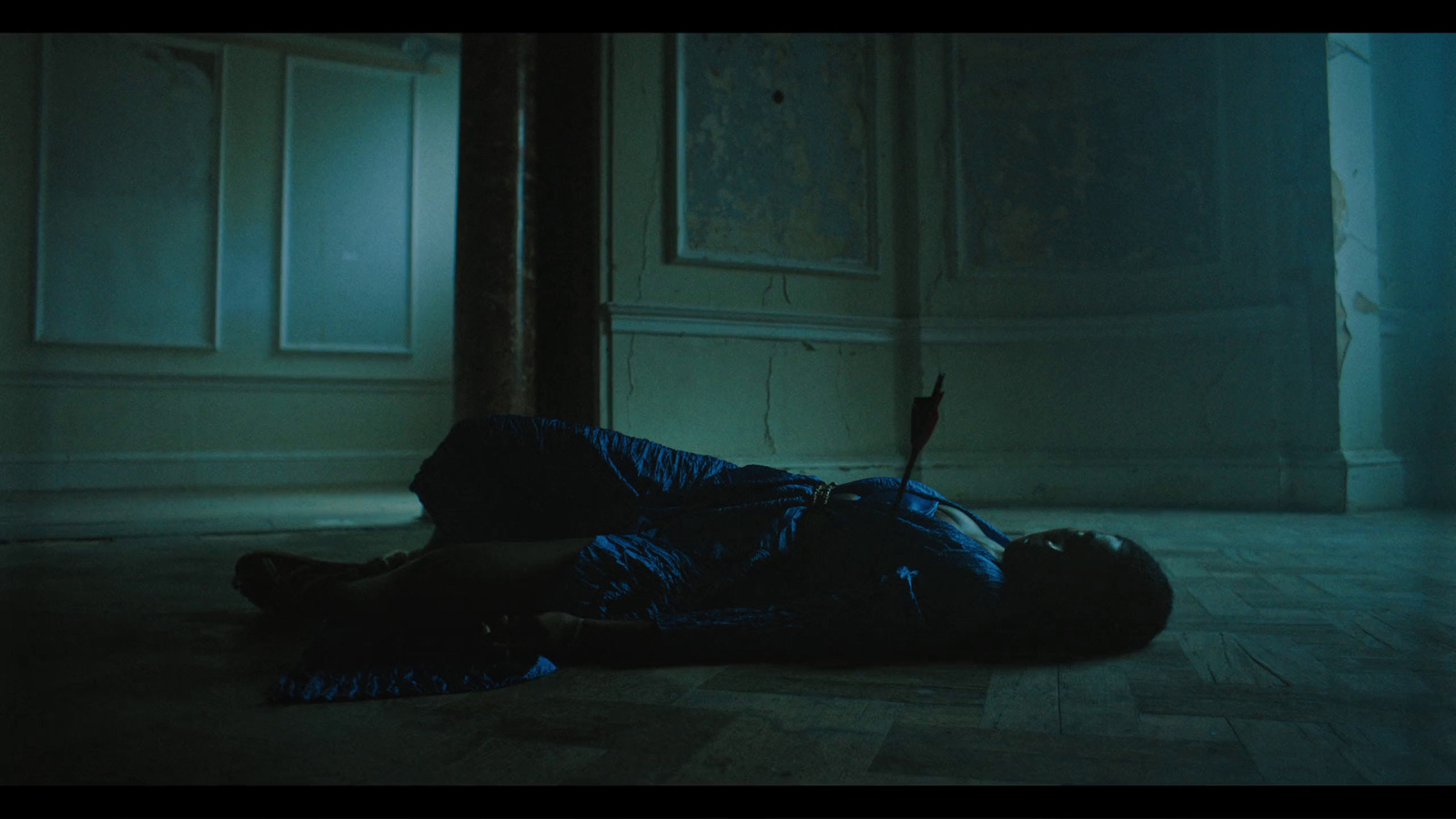 a person laying on the floor in a dark room