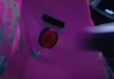 a close up of a pink object with a red light