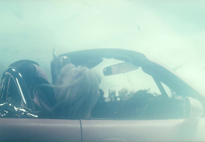 a woman sitting in the passenger seat of a car