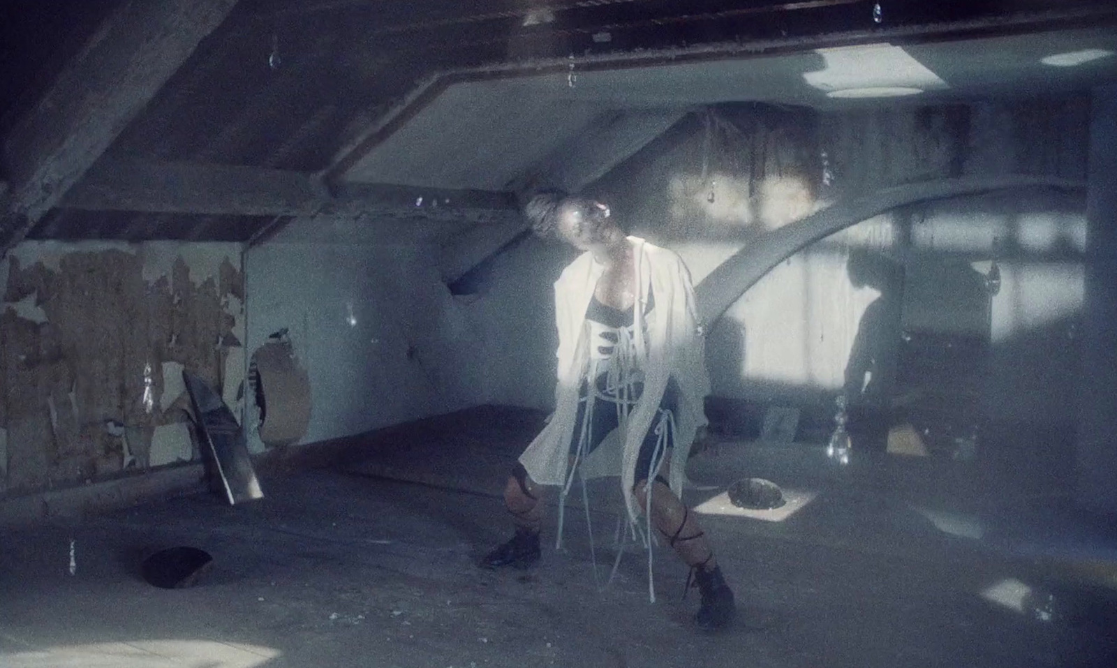 a woman standing in a room with a ladder