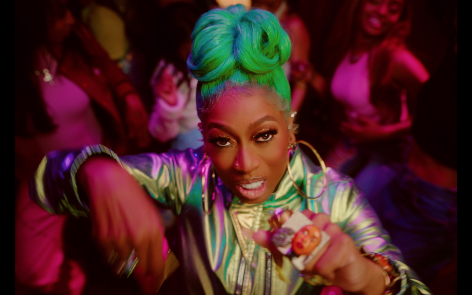 a woman with green hair is dancing