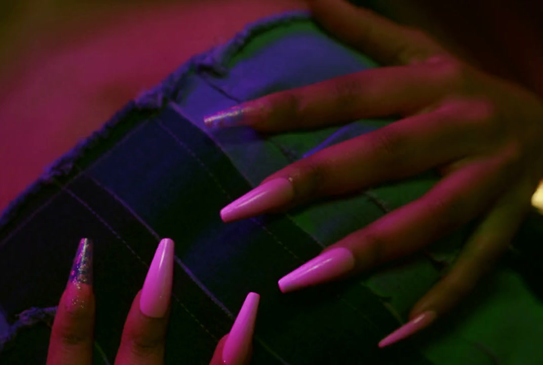 a woman's hands with pink and purple nails