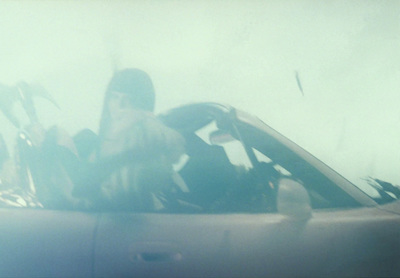 a woman sitting in the driver's seat of a car