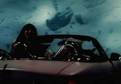 a person sitting in a car in a dark room