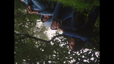 a group of men standing on top of a lush green forest