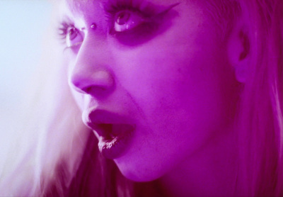 a close up of a person with purple makeup