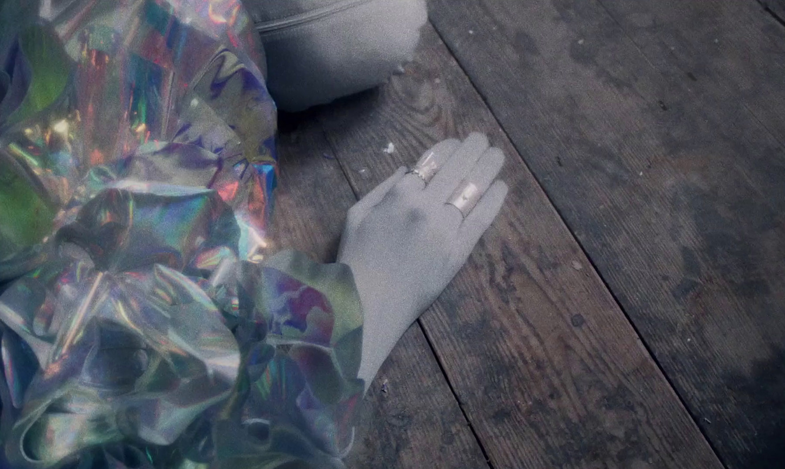 a pair of white gloves sitting on top of a wooden floor