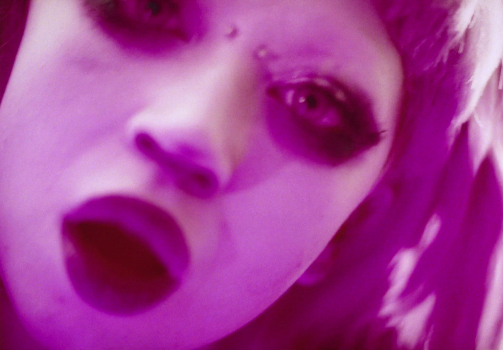 a close up of a person with purple makeup