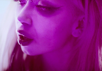 a close up of a person with purple makeup