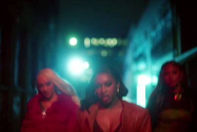 a group of people walking down a street at night