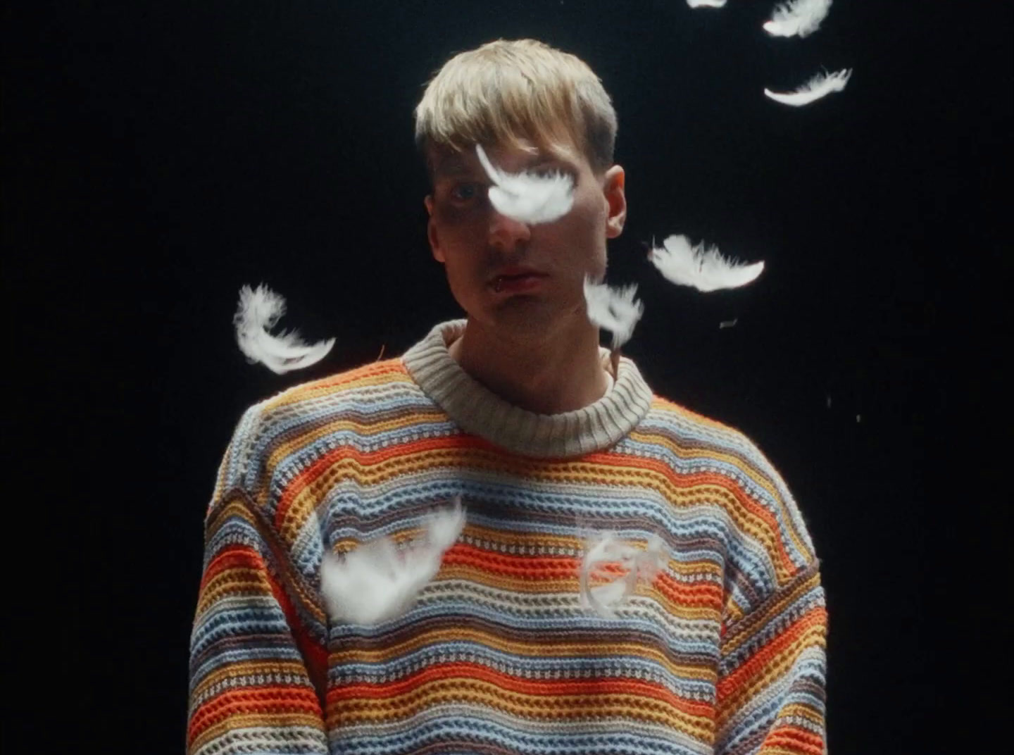 a man standing in front of a black background