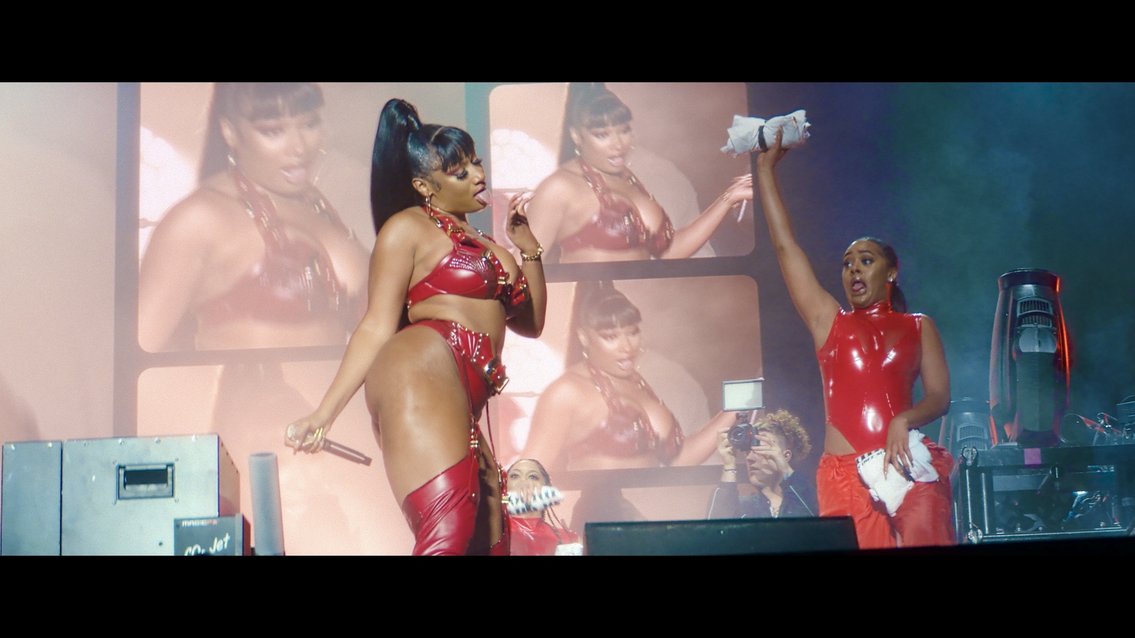 a couple of women standing on top of a stage