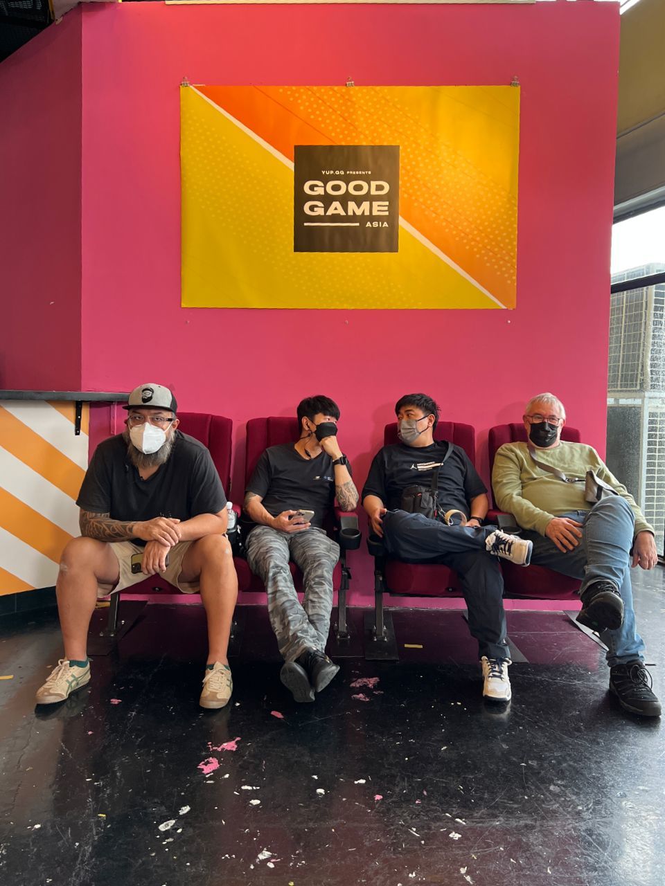 a group of people sitting on top of a pink bench