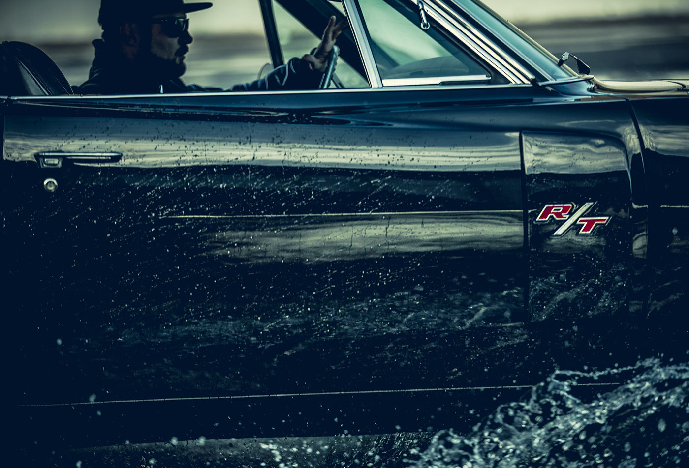 a man sitting in a car in the water