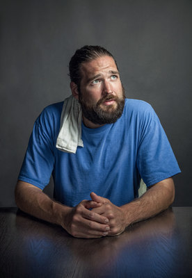 a man with a beard sitting at a table