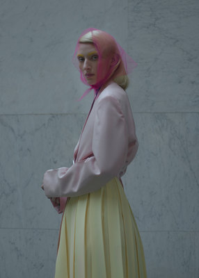 a woman with pink hair wearing a yellow dress