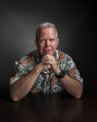 a man sitting at a table with his arms crossed