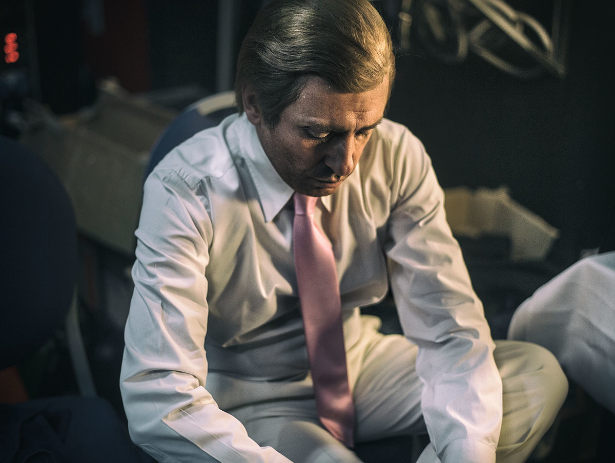 a man in a white shirt and pink tie