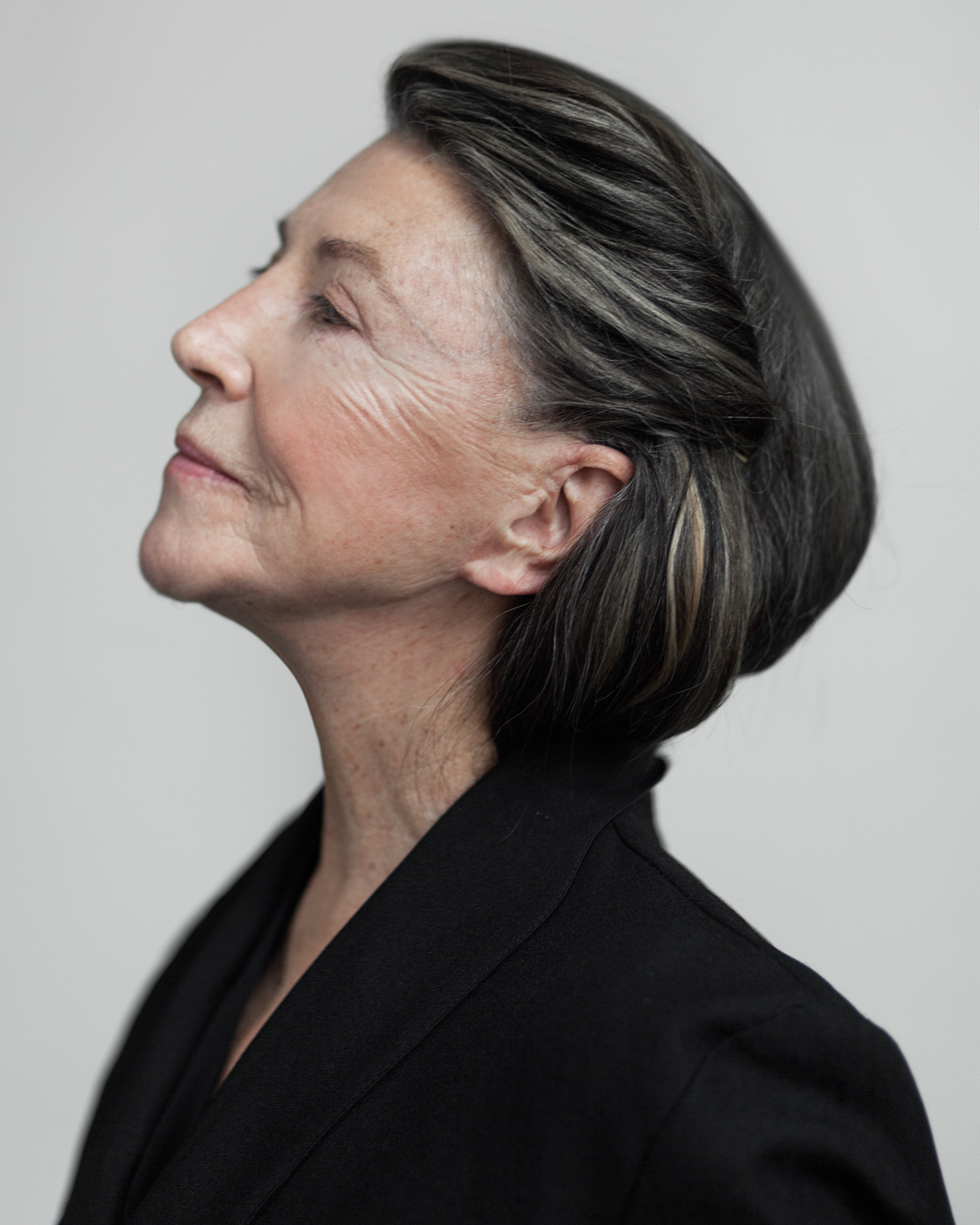 a woman with a black jacket and a white background