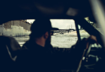 a man driving a car in the rain