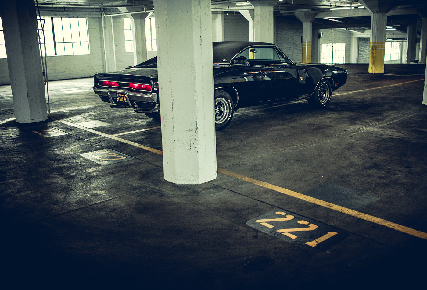 a black car parked in a parking garage