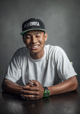 a man sitting at a table wearing a hat