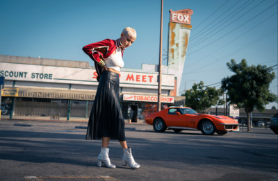 a woman standing in the middle of a street