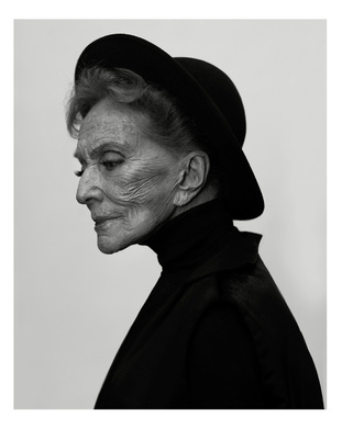 a black and white photo of a woman wearing a hat