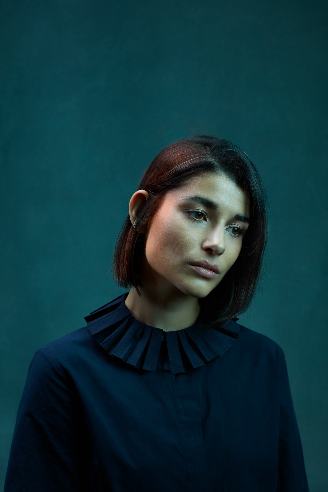 a woman with dark hair and a black shirt