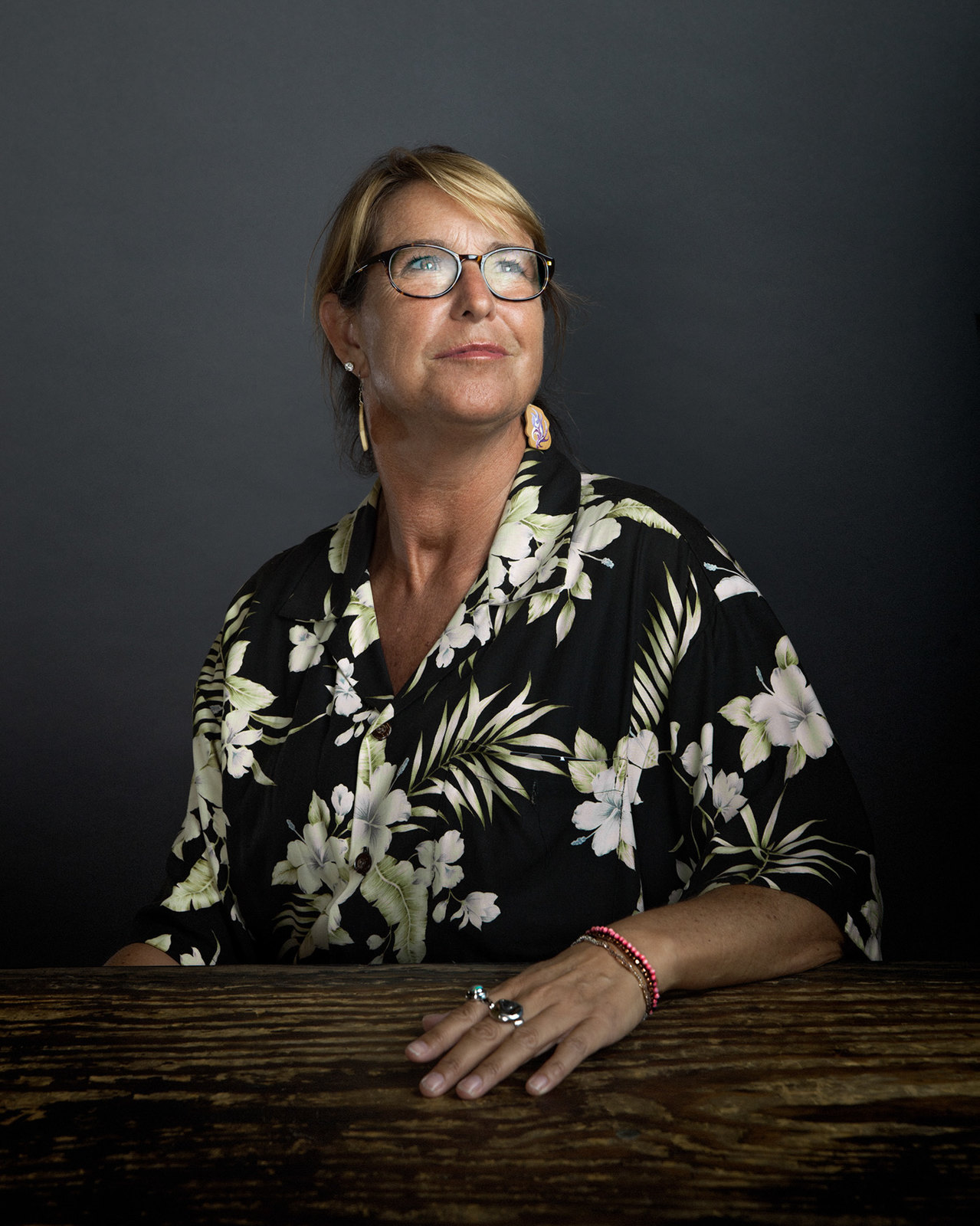 a woman with glasses sitting at a table