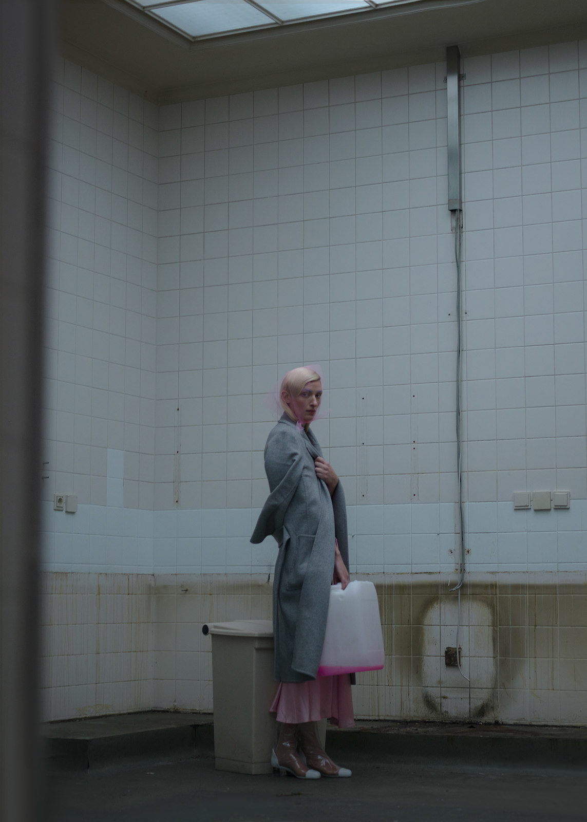 a woman in a bath room holding a bag