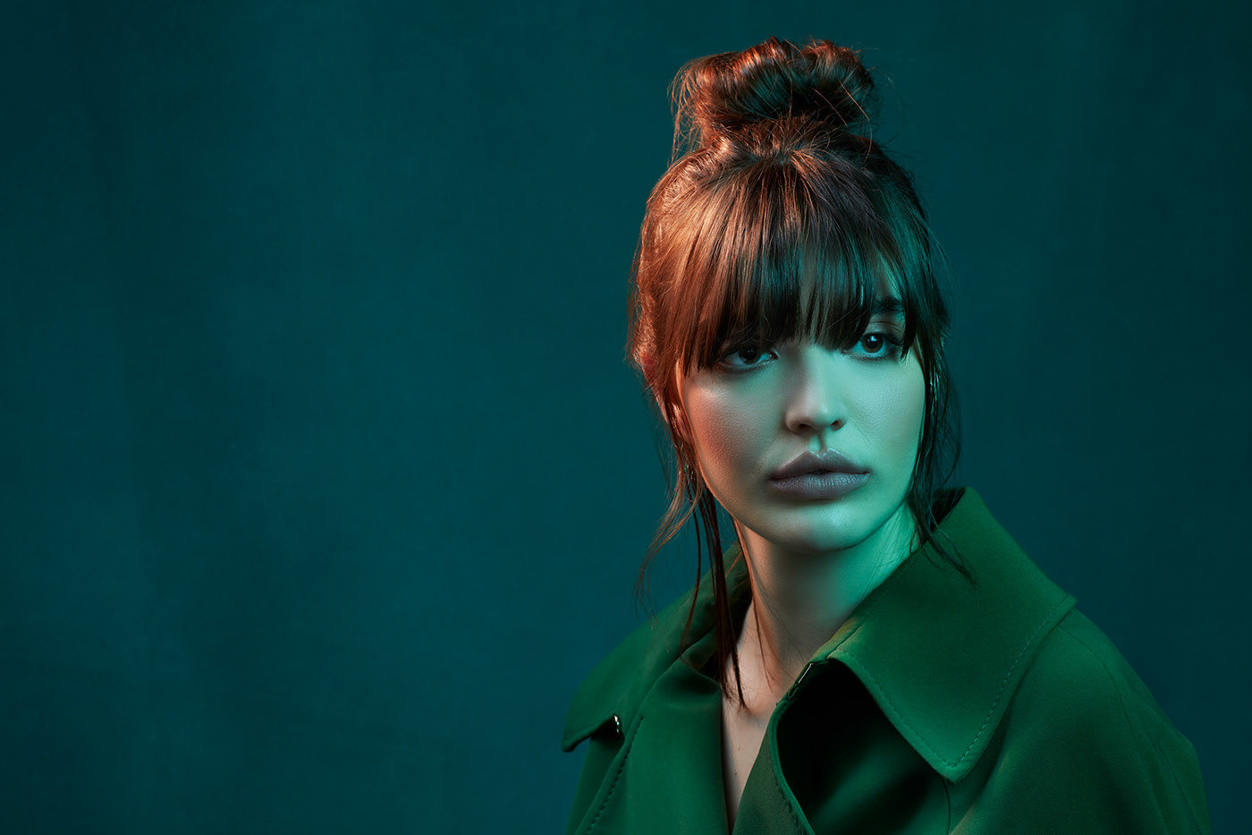 a woman with red hair and a green shirt