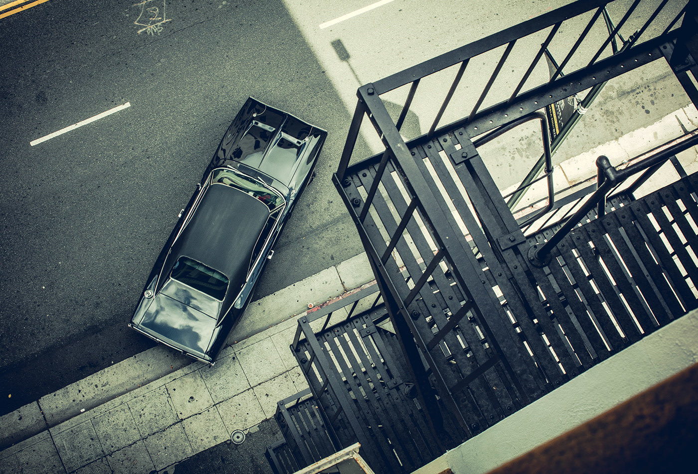 an overhead view of a car parked on the side of a street