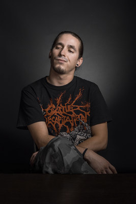 a man sitting on top of a wooden table